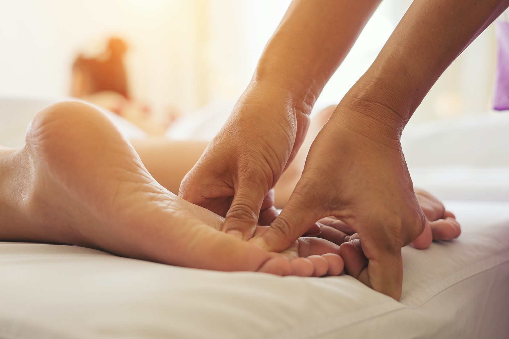 reflexology treatment on patient foot by our professionals